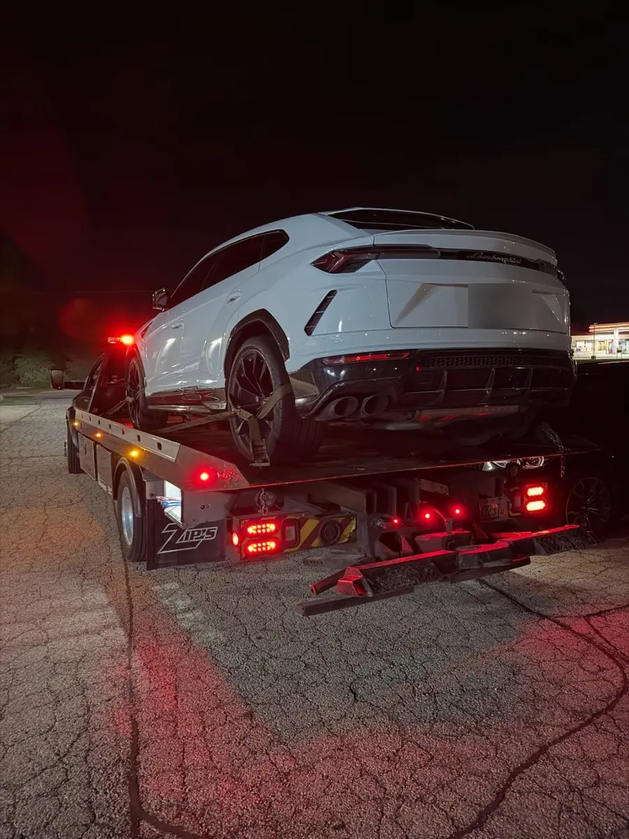 Lamborghini Urus secured with wheel straps on the flatbed